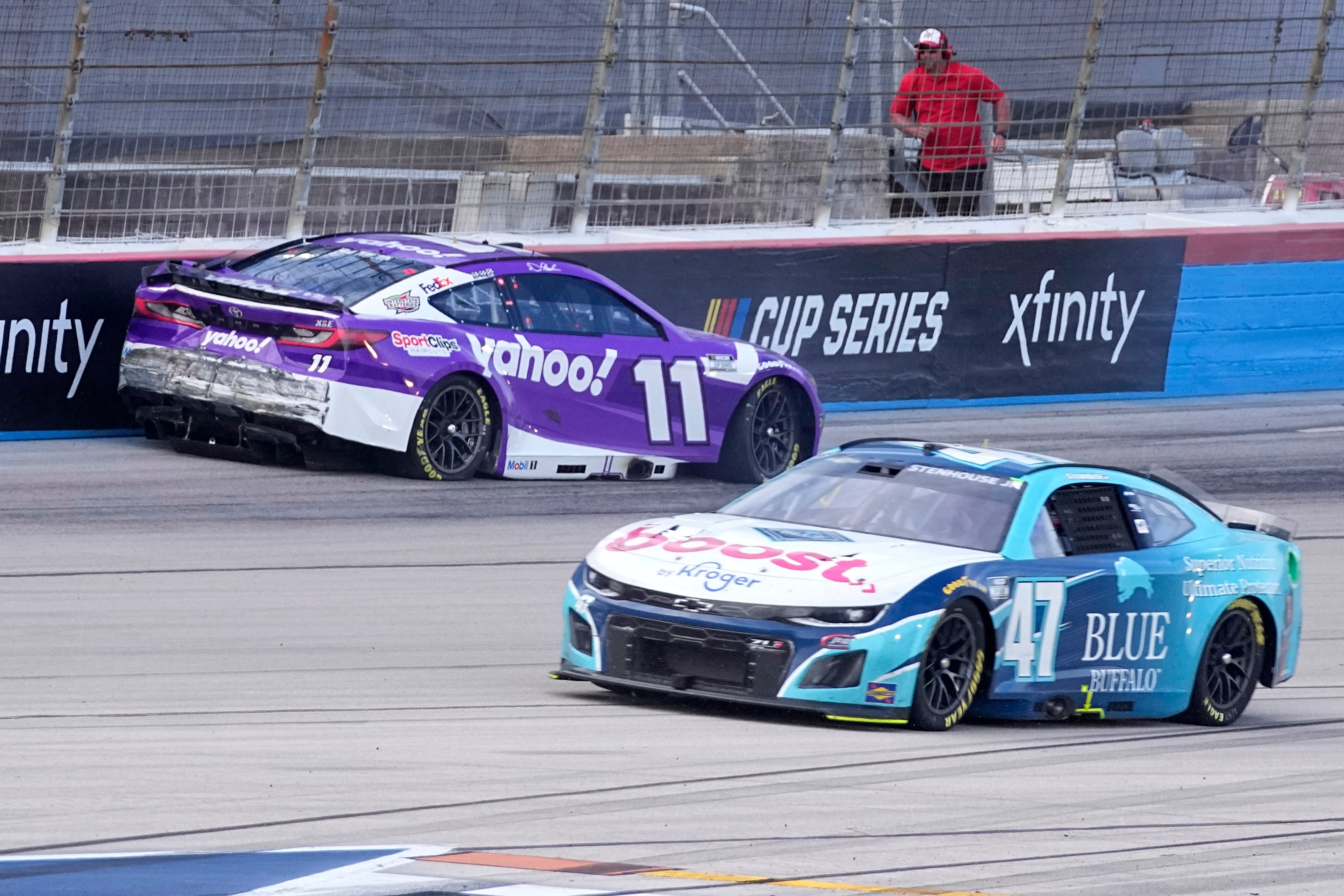 Denny Hamlin (11) crashes coming out of Turn 4 in the final laps as Ricky Stenhouse Jr. (47)...