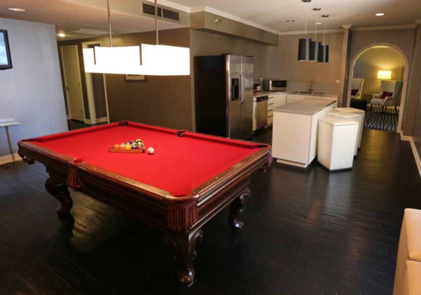 One of the updated rooms features a pool table. HD TVs also were added, as were desks with...