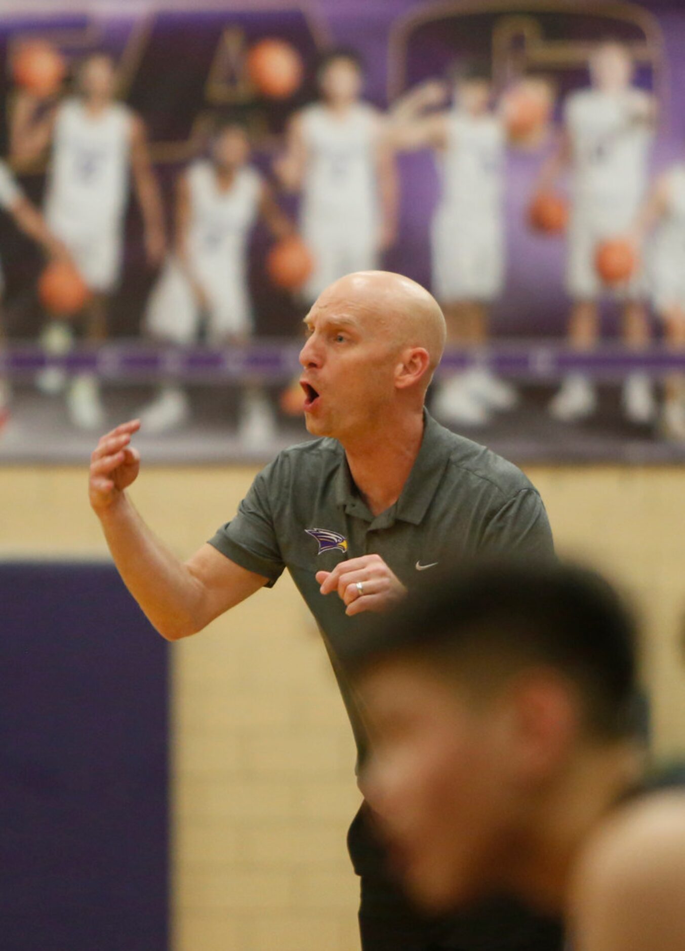 Richardson head coach Kevin Lawson delivers a message to his players from the bench area...