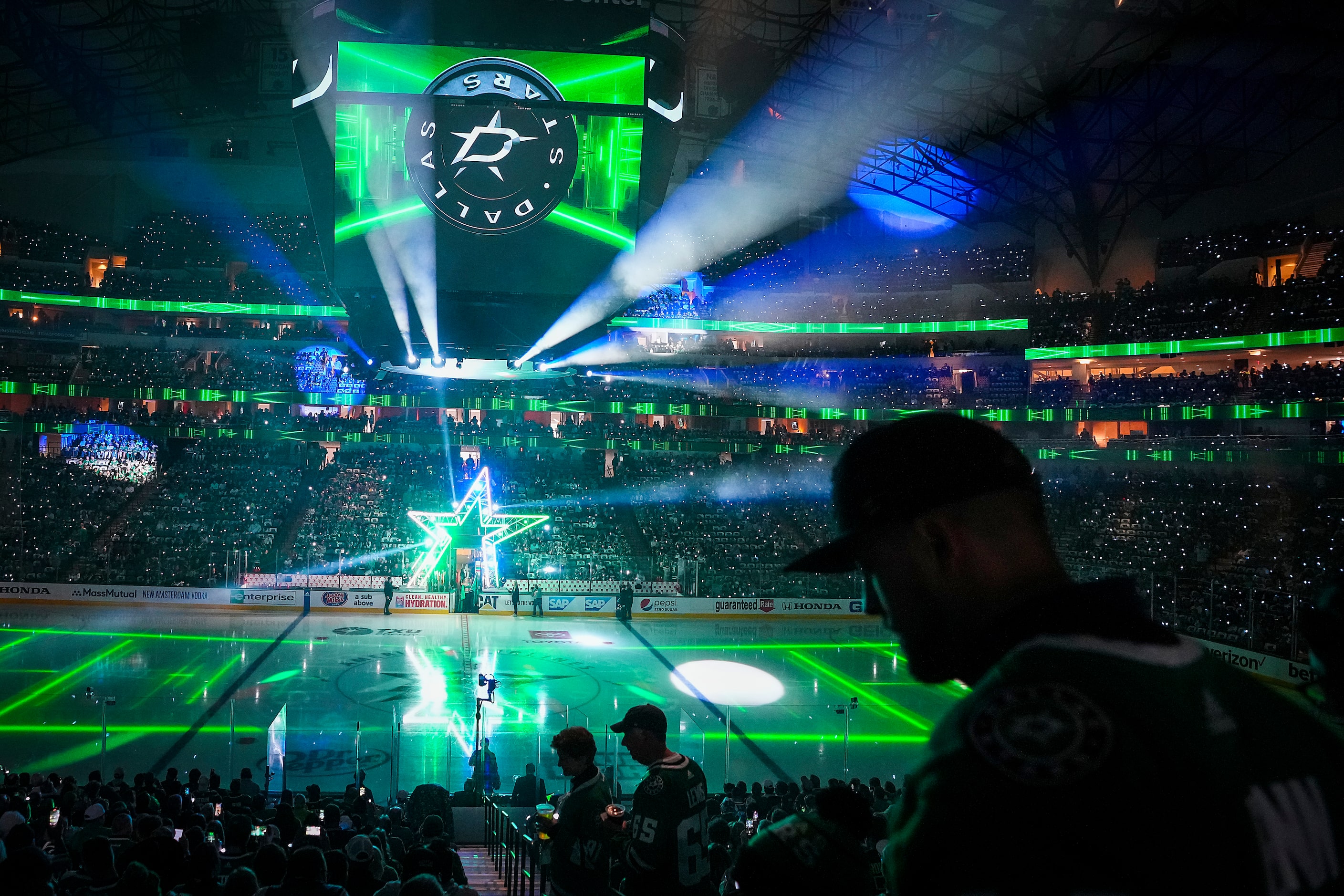 Dallas Stars fans take their seats during a light show at the arena before Game 3 of the...