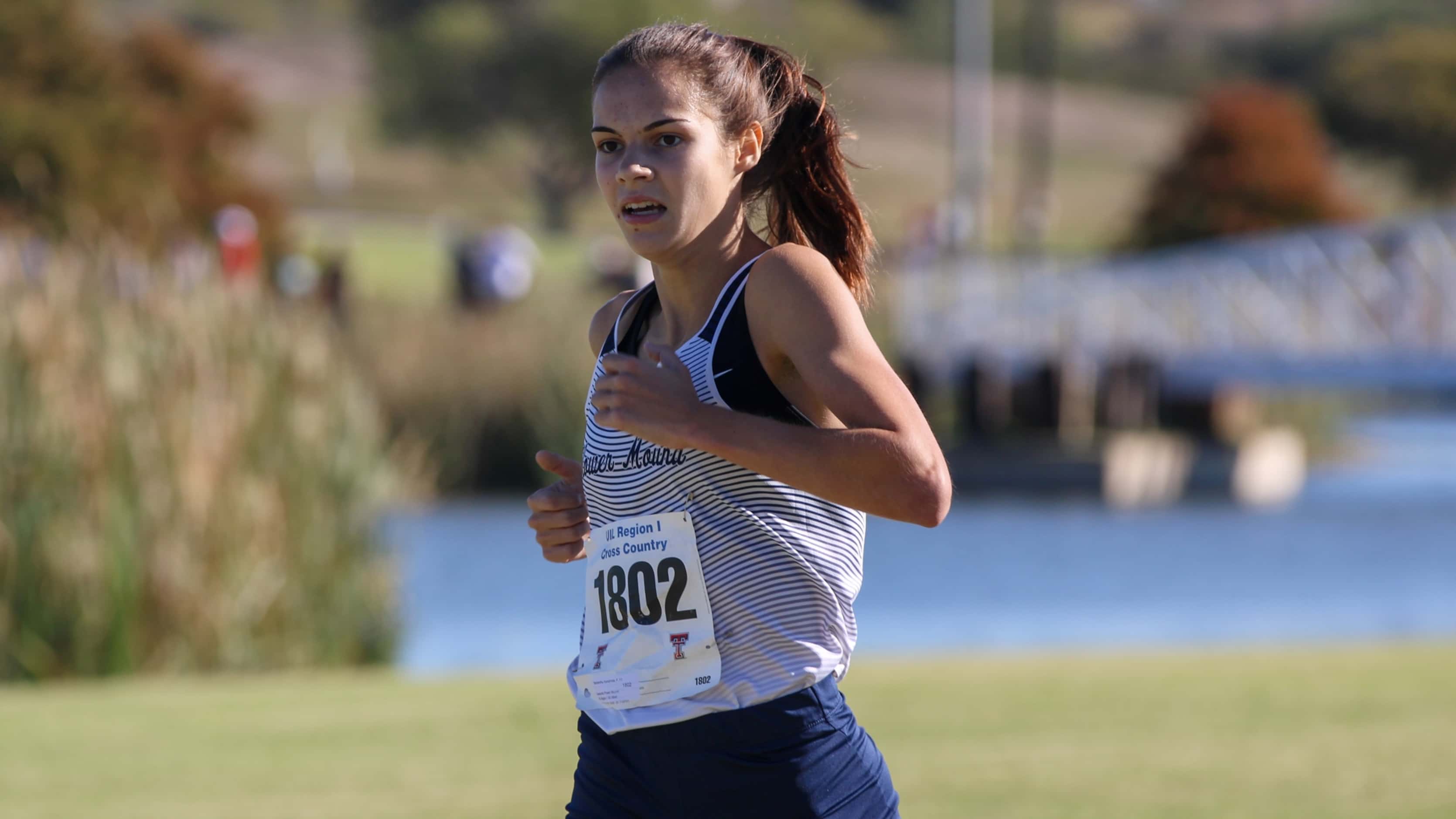 Flower Mound’s Samantha Humphries finishes off the victory in the Region I-6A girls cross...