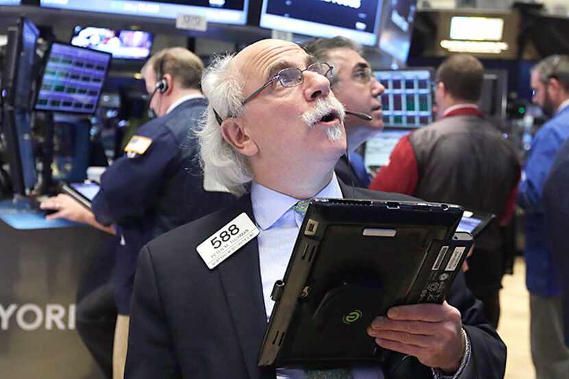 
A trader kept an eye on stocks Wednesday at the New York Stock Exchange, where falling oil...