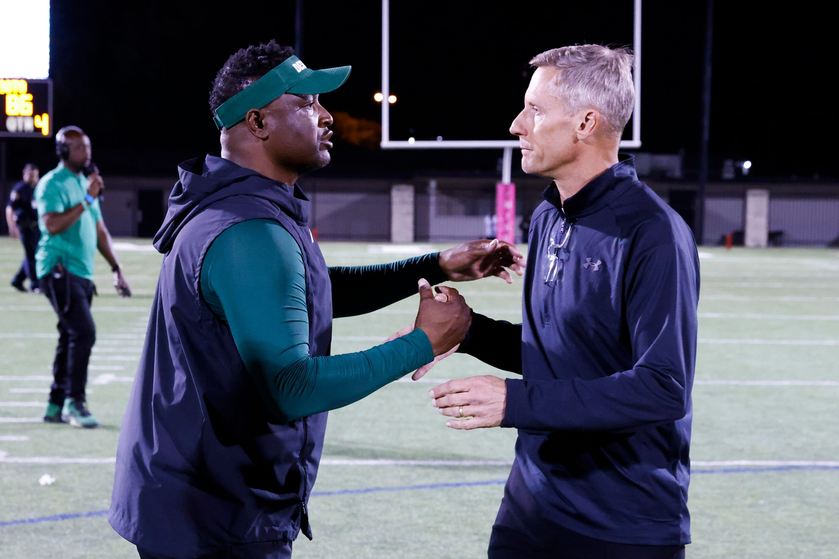 DeSoto high head coach Claude Mathis, left, and Lake Ridge High head coach Kirk Thor shakes...