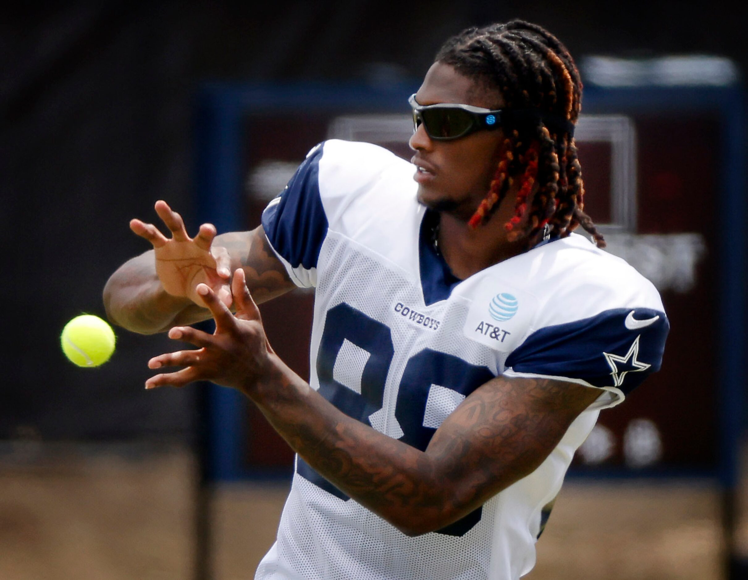 Dallas Cowboys wide receiver CeeDee Lamb (88) catches tennis balls during training camp...