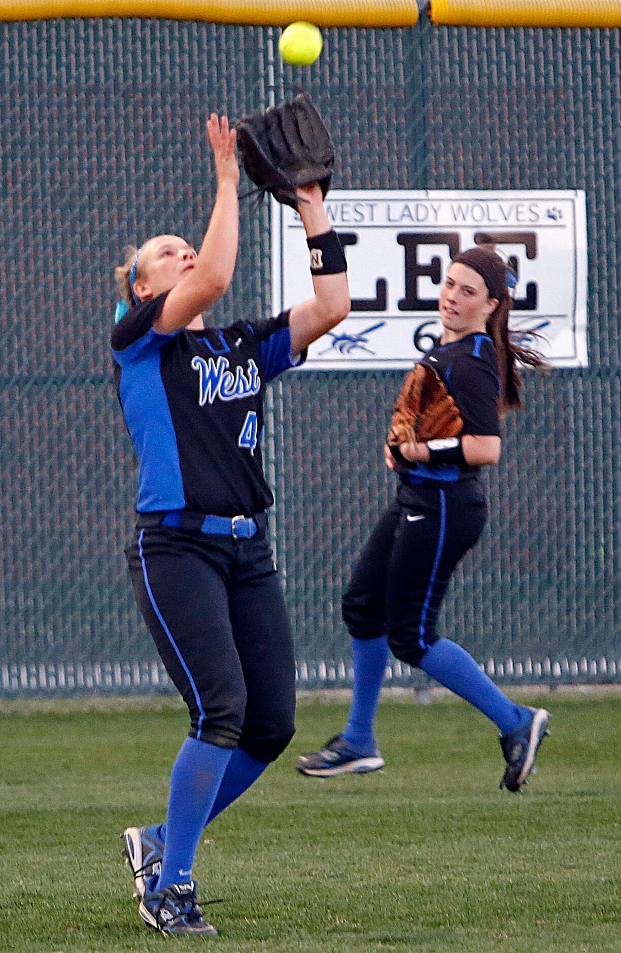 Plano West High School outfielder Kelsey Vining (4) catches an out against Plano East High...