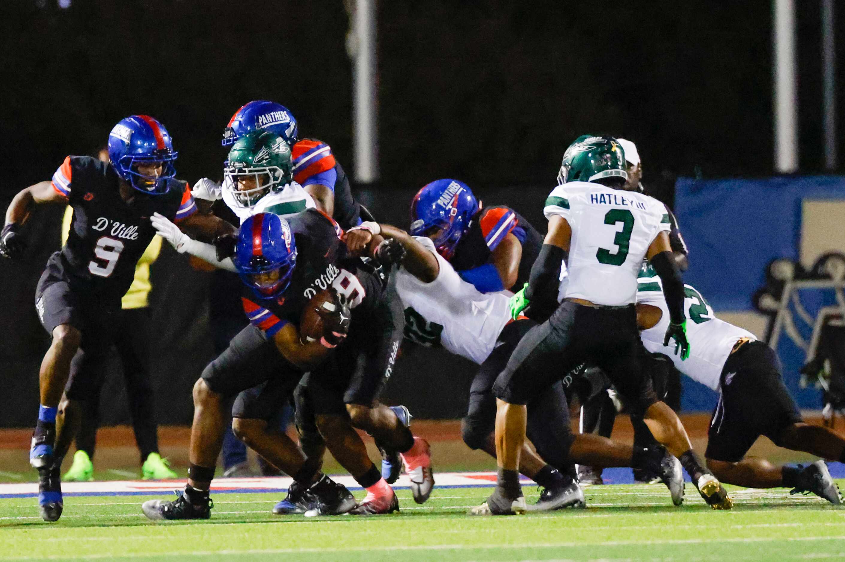 Duncanville running back Caden Durham (29) is grabbed by Waxahachie line backer La’Markus...