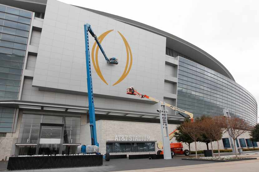 The College Football Playoff National Championship Logo being applied to AT&T Stadium on Jan...