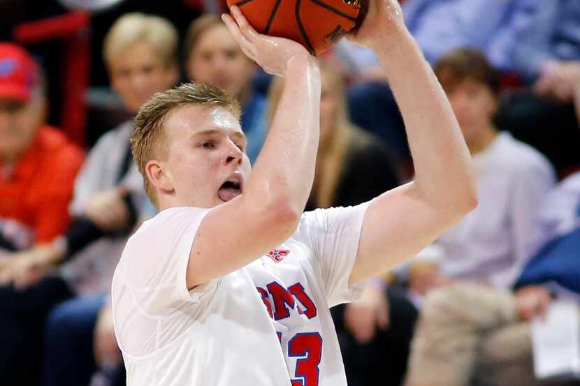 Southern Methodist Mustangs forward Harry Froling (13) puts up and makes a three point shot...