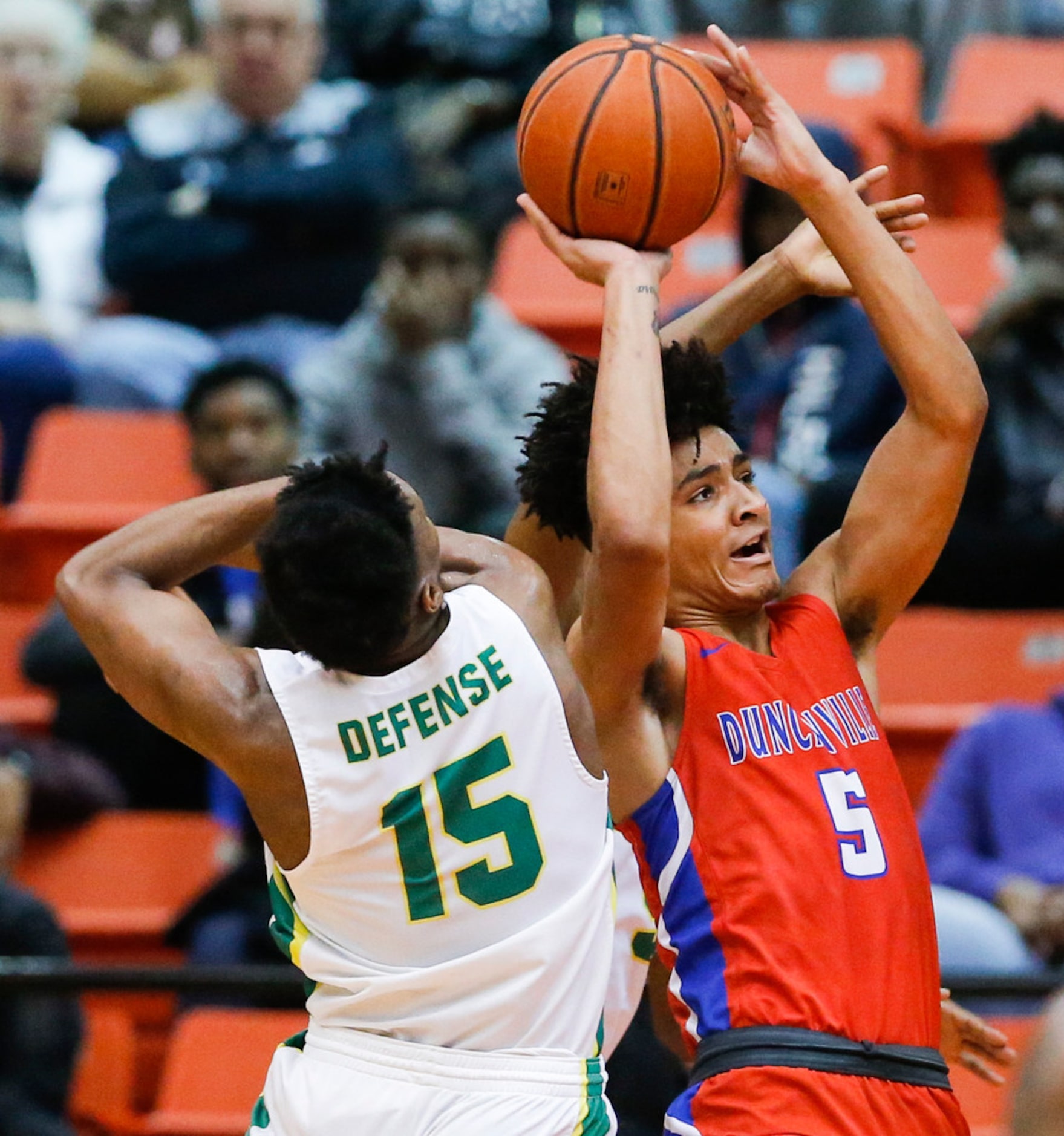 Duncanville junior guard Micah Peavy attempts a shot as DeSoto senior guard Claven Wilson...