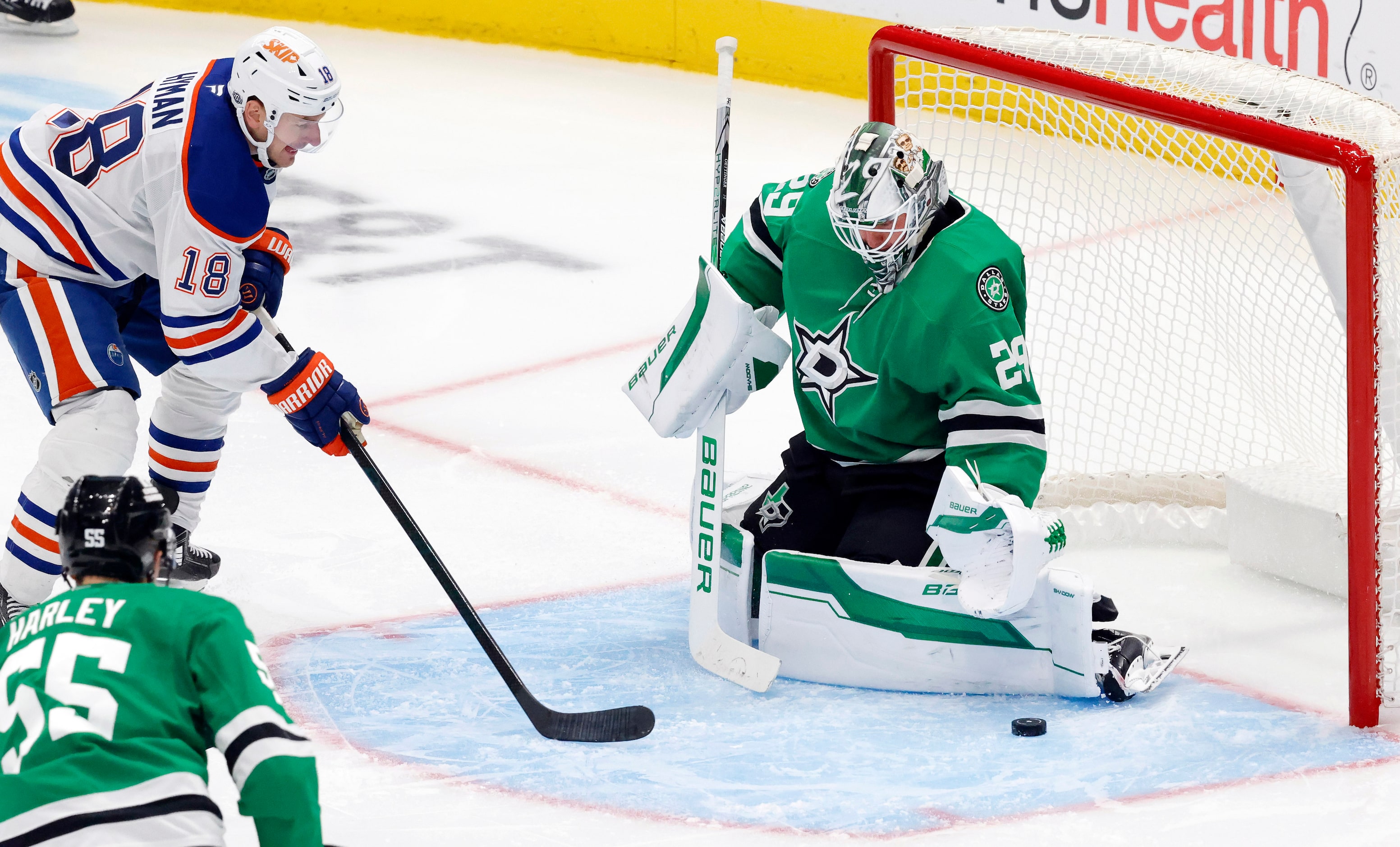 Dallas Stars goaltender Jake Oettinger (29) deflects a shot by Edmonton Oilers left wing...