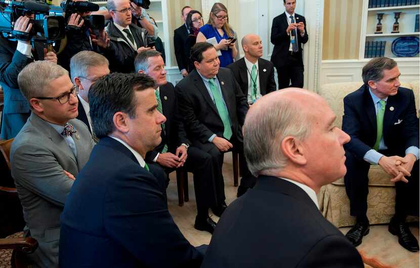 Texas Reps. John Ratcliffe (left in foreground) and Blake Farenthold (seated in back row,...