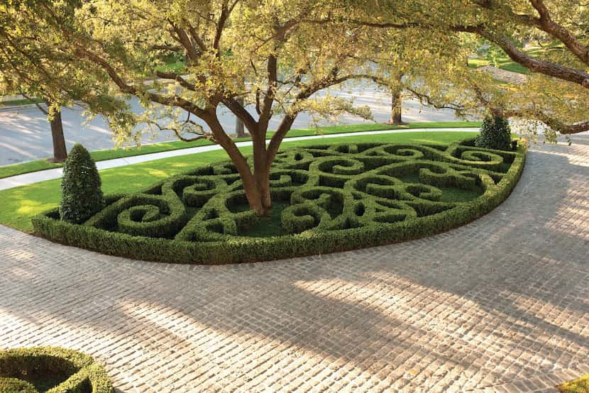 This home's driveway features a classic cobblestone design by Harold Leidner Landscape...