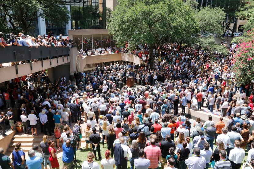 People gathered for a faith vigil during a citywide prayer service in downtown Dallas on...