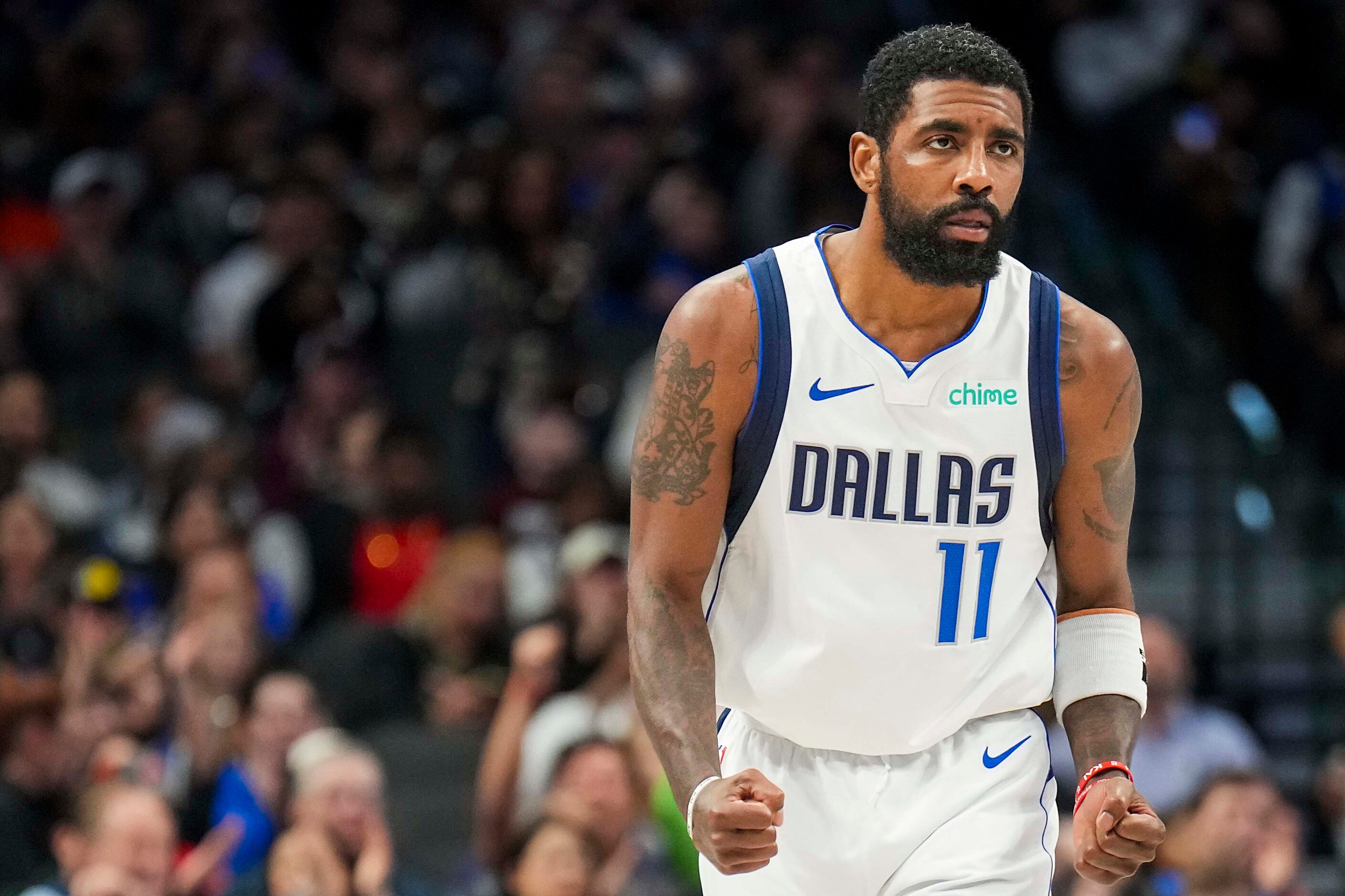 Dallas Mavericks guard Kyrie Irving celebrates after scoring during the second half of an...