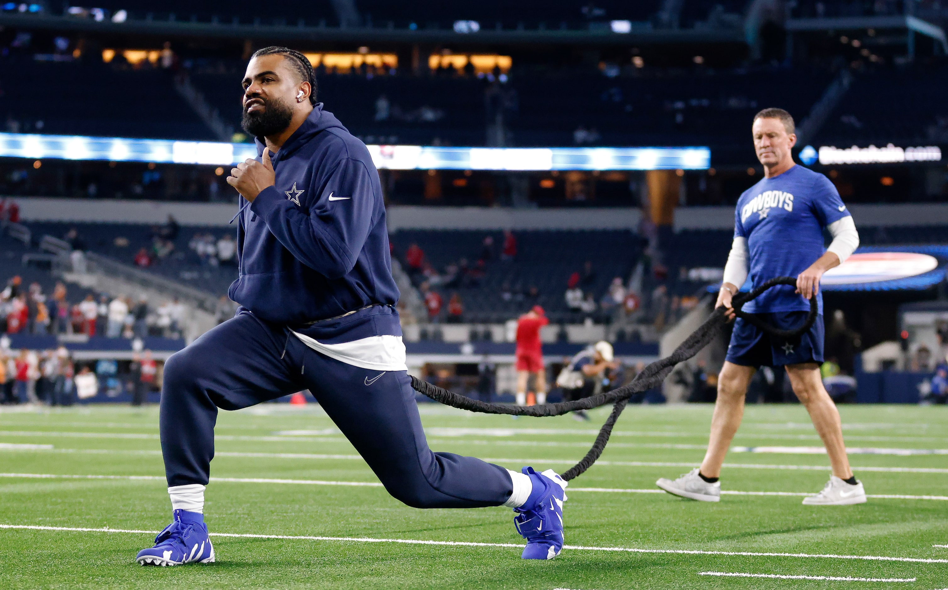 Dallas Cowboys running back Ezekiel Elliott stretches on the exercise cord during pregame...