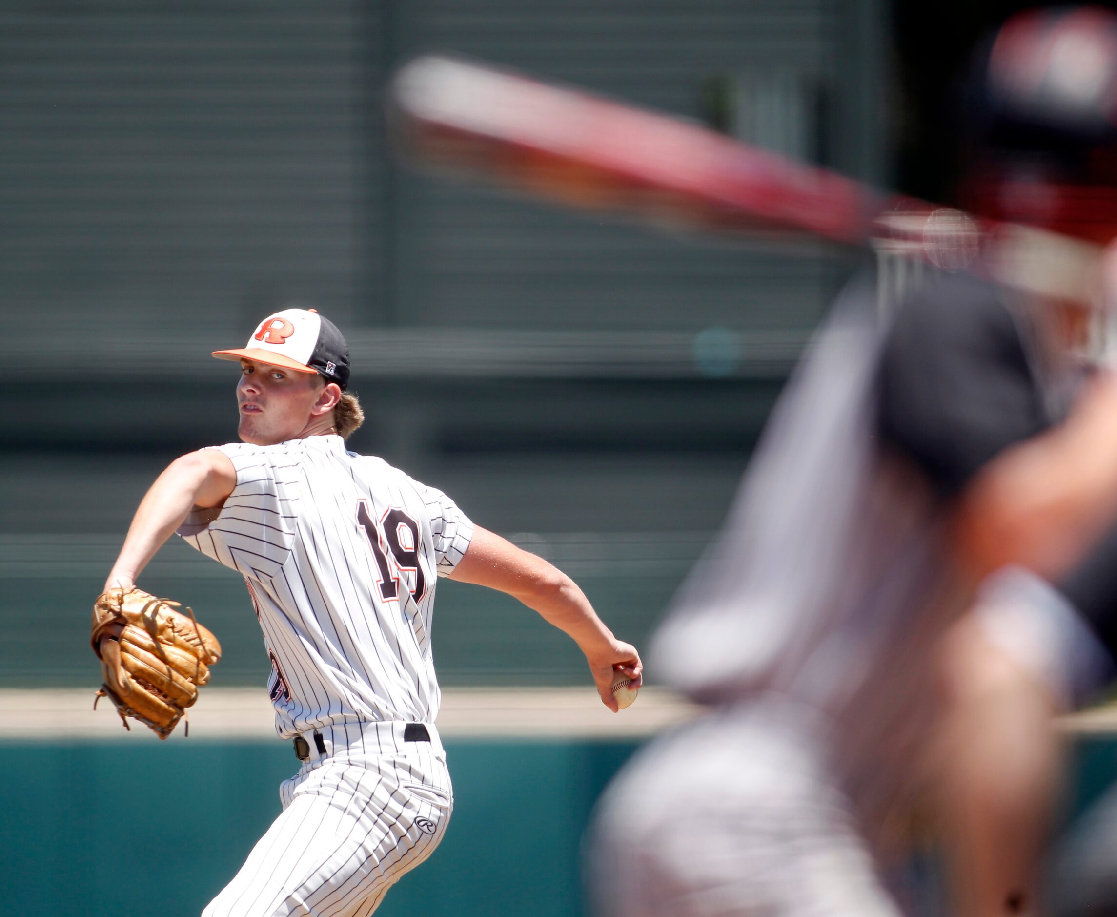 Rockwall pitcher Charlie Ciese (19) delivers a pitch to a Rockwall Heath batter during the...