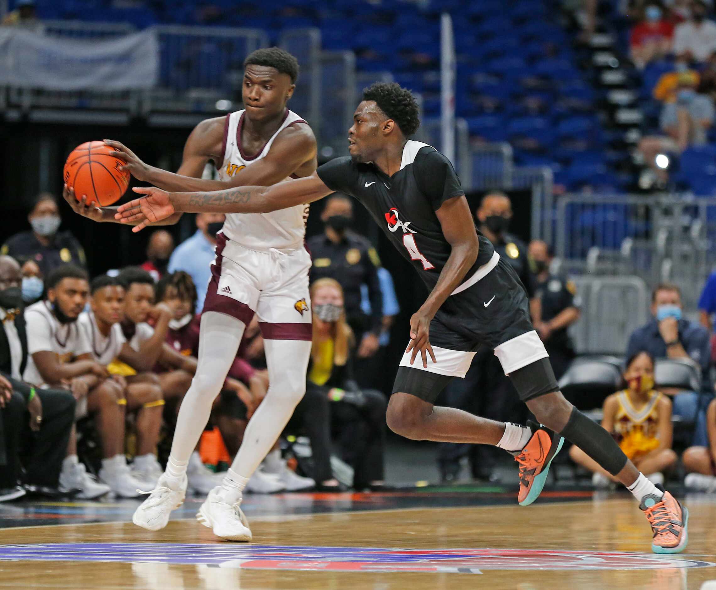 Dallas Kimball Kyron Henderson #4 tries for a steal. UIL boys Class 5A basketball state...