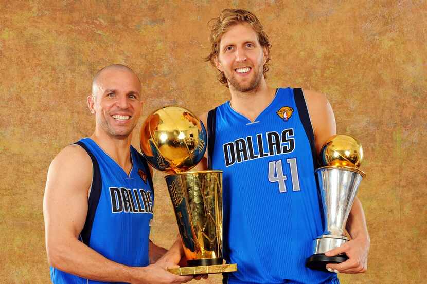 Jason Kidd (left) and Dirk Nowitzki pose with the NBA championship trophy. Nowitzki is...