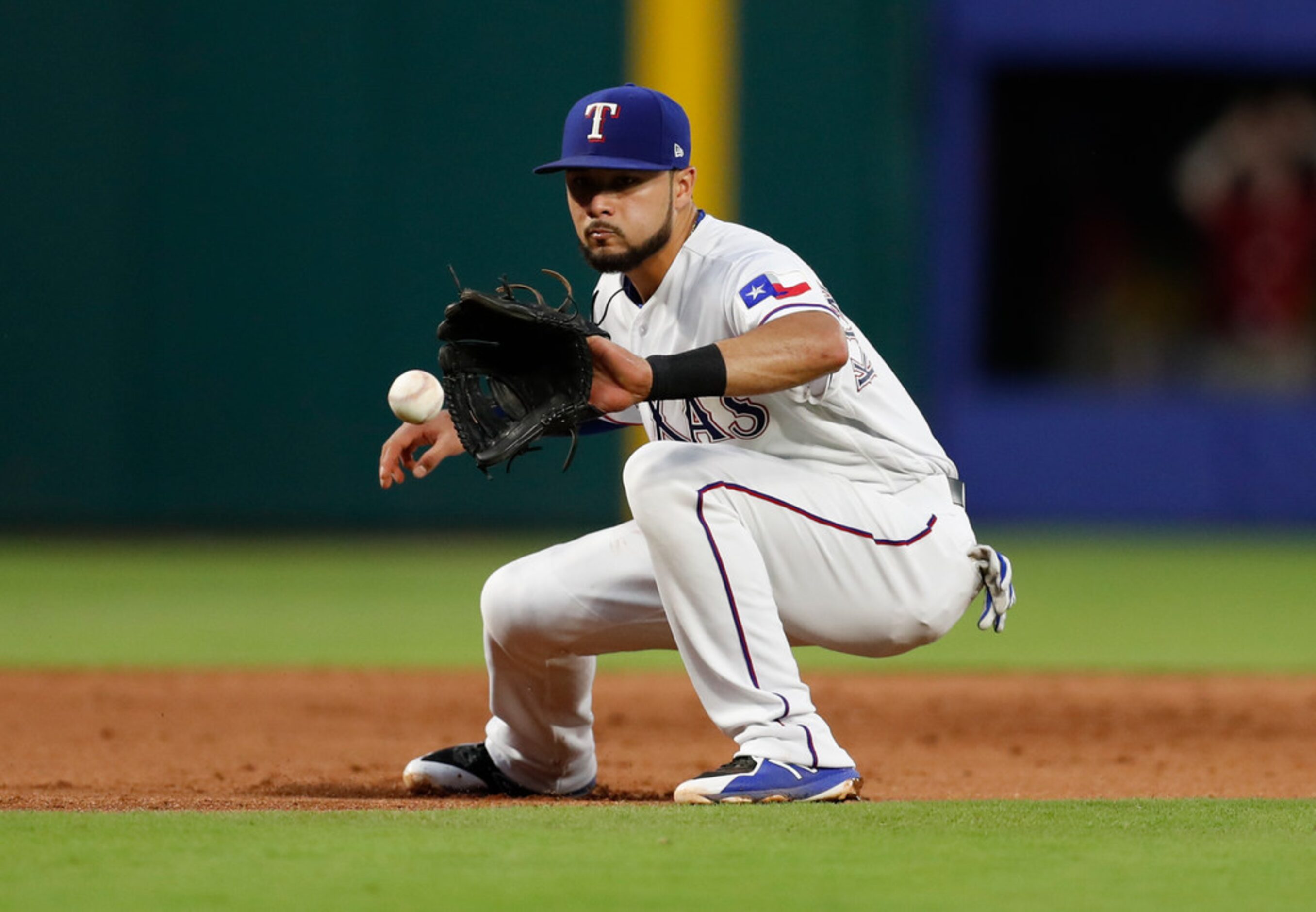 Texas Rangers third baseman Isiah Kiner-Falefa fields the ground out hit by Oakland...