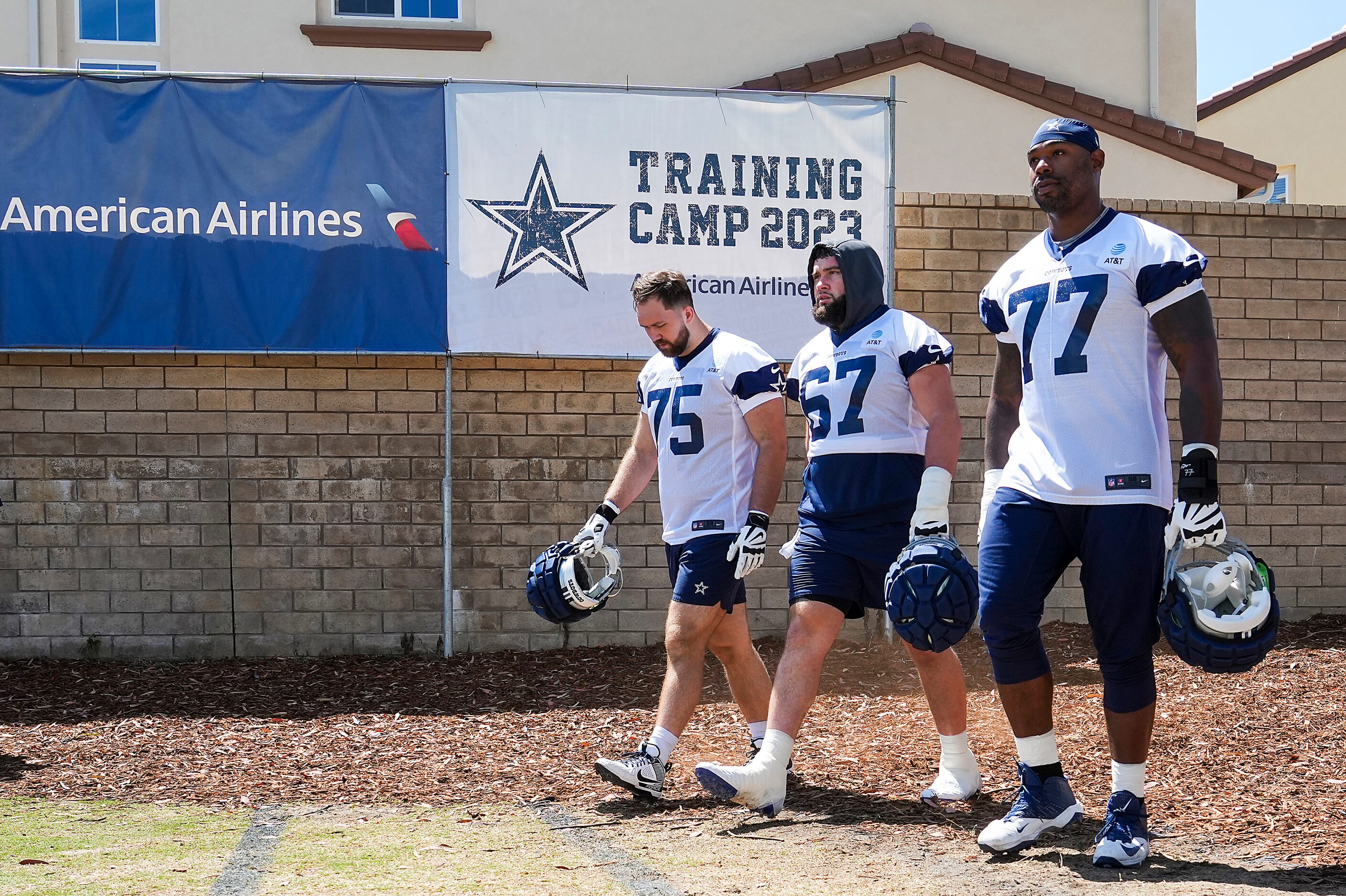 Dallas Cowboys offensive linemen Josh Ball (75), Brock Hoffman (67) and Tyron Smith (77)...