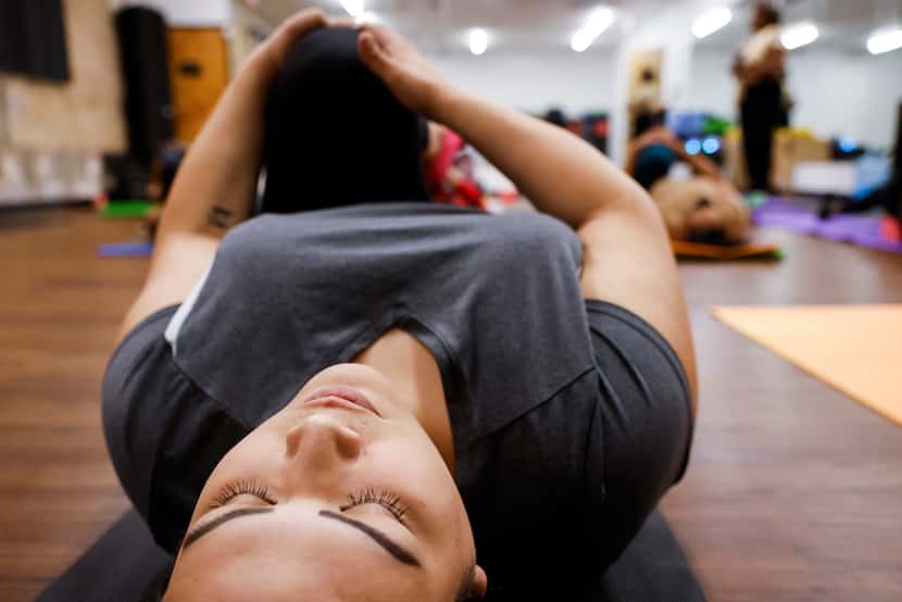 Stacey Monroe of Dallas closes her eyes during a yoga session at Abounding Prosperity.