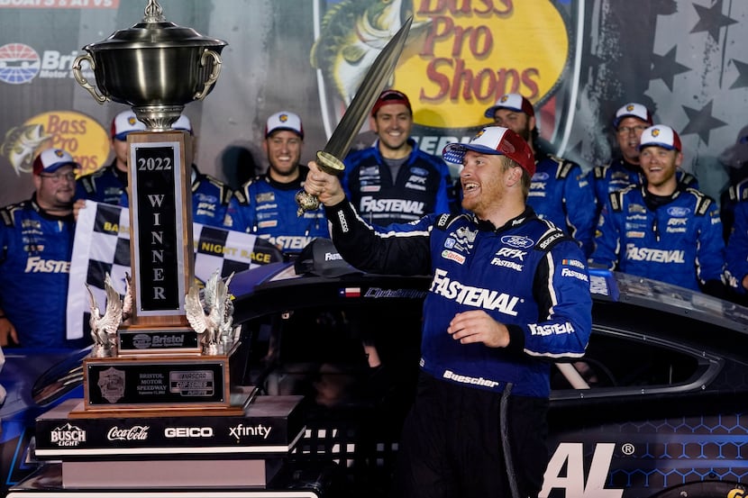 Chris Buescher celebrates with his trophy and sword after winning a NASCAR Cup Series auto...
