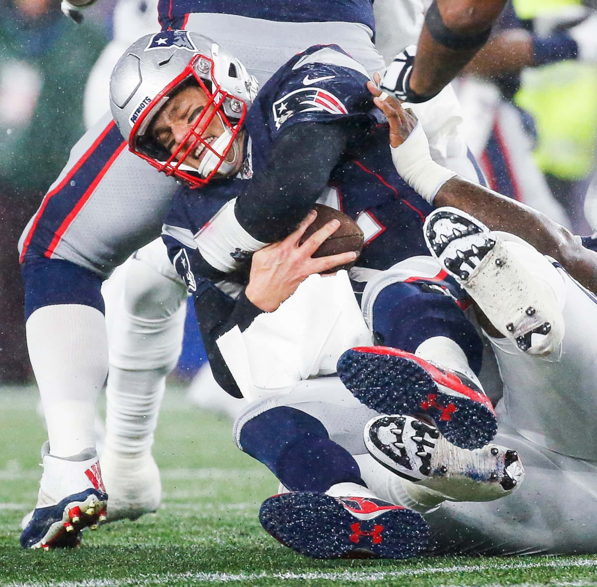 New England Patriots quarterback Tom Brady (12) is sacked by Dallas Cowboys defensive tackle...