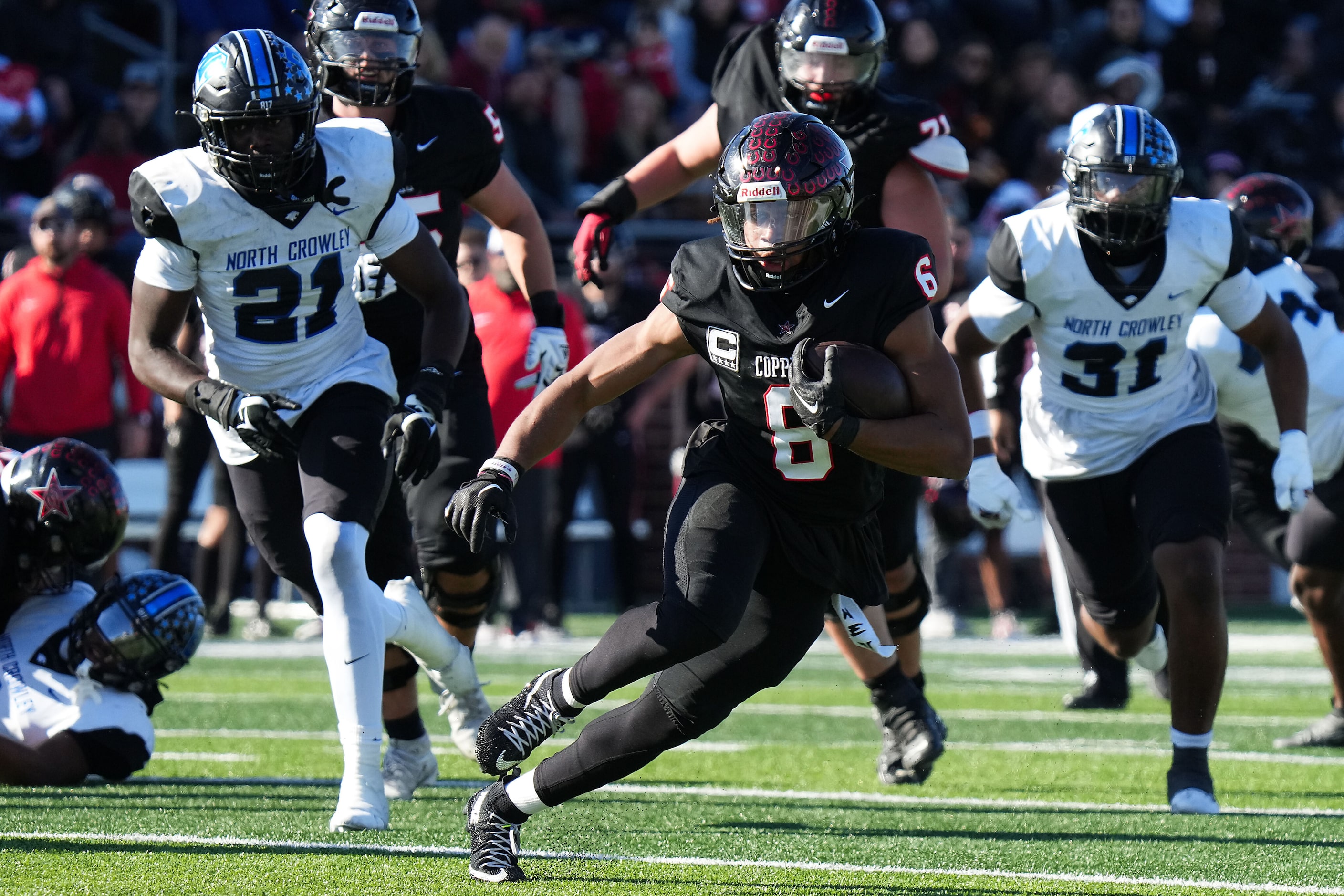 Coppell running back O'Marion Mbakwe (6) breaks through the North Crowley defense during the...