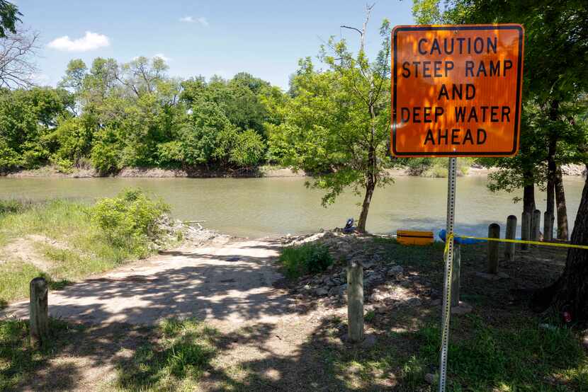 A sign warns of deep water and a steep ramp at California Crossing Park.