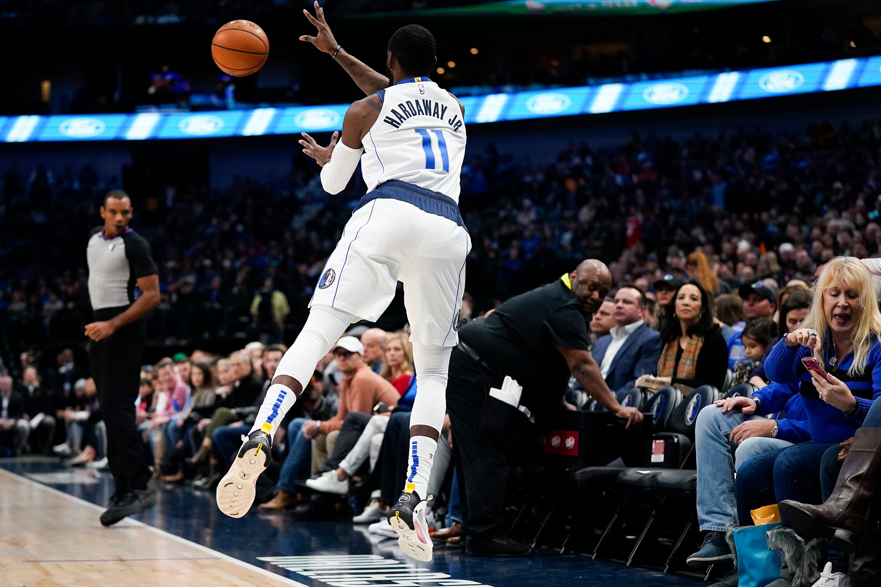 Dallas Mavericks guard Tim Hardaway Jr. (11) flies out of bounds to save a ball during the...