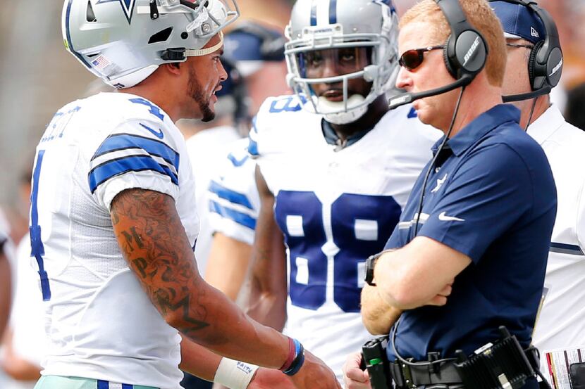 Dallas Cowboys quarterback Dak Prescott (4)  talks with Dallas Cowboys head coach Jason...