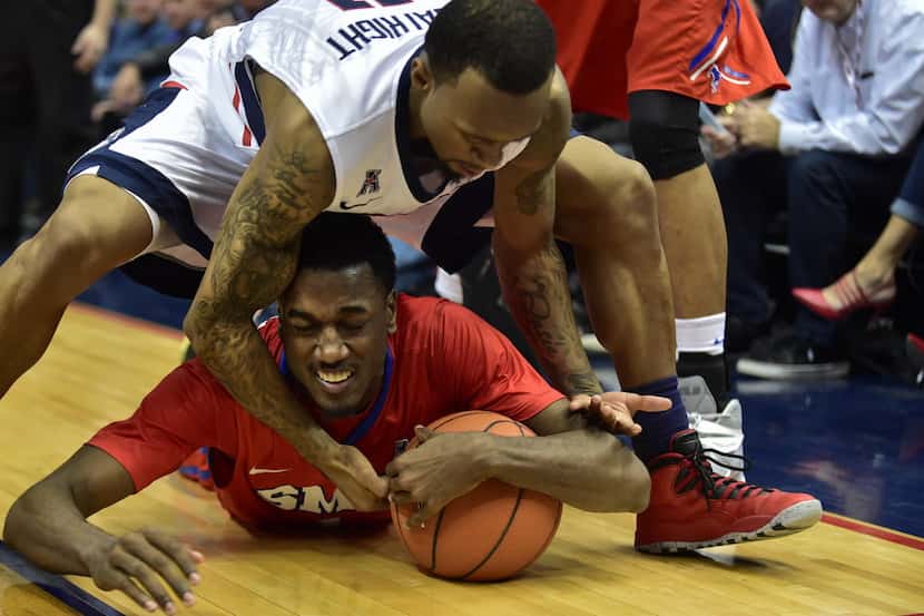 UConn's Ryan Boatright and Southern Methodist's Ryan Manuel fight for control of a loose...