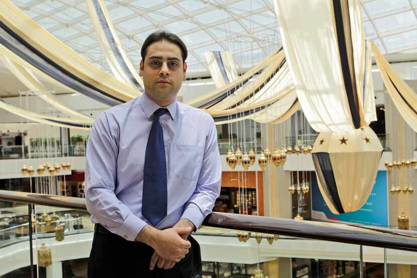 Rafat Awad, a 23 year old pharmacist, poses for a portrait at a shopping mall in Dubai,...
