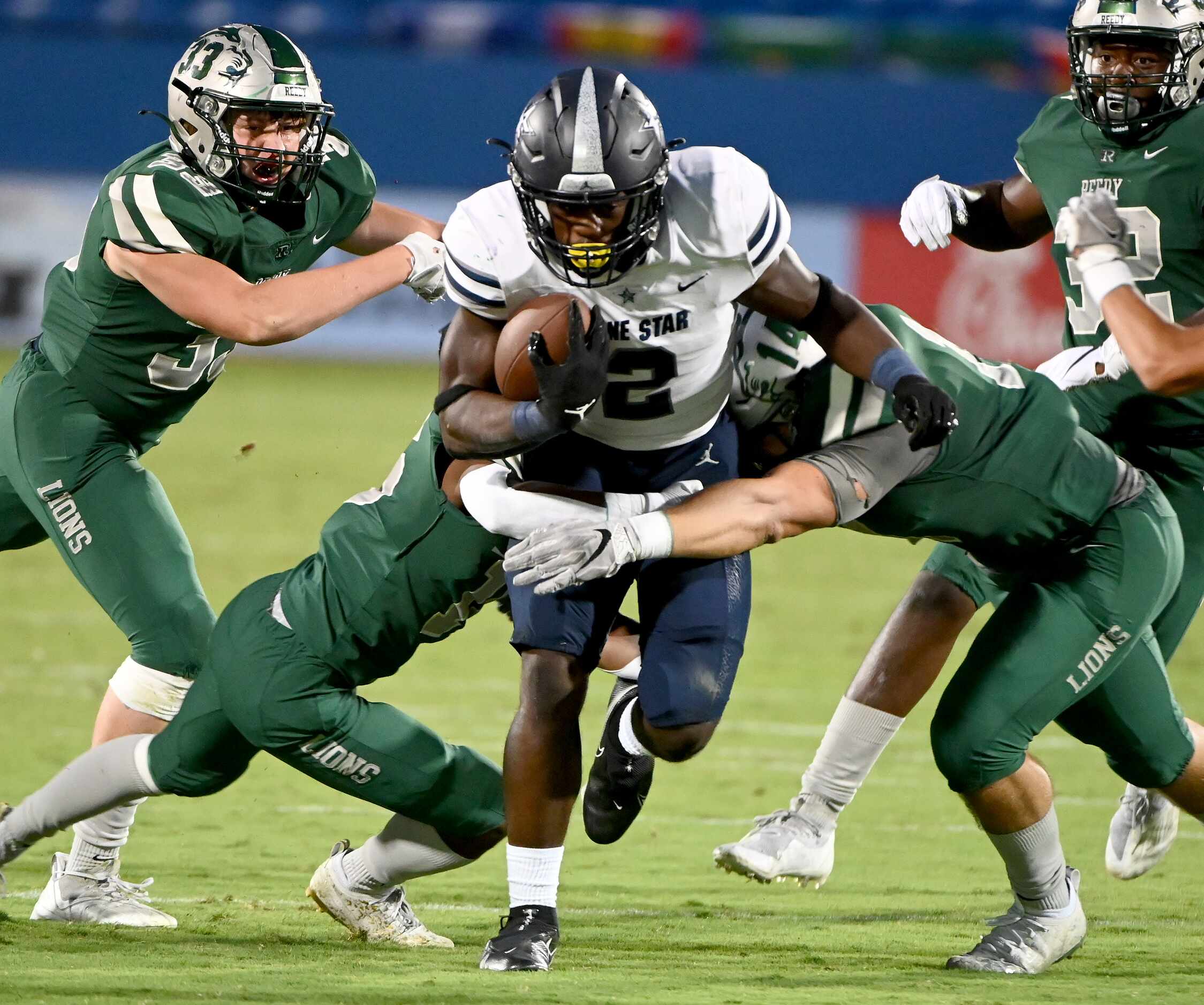 Frisco Lone Star’s Ashton Jeanty (2) runs through the tackle attempts of Frisco Reedy’s...