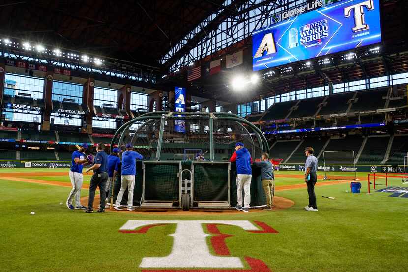 Texas Rangers players take batting practice during a workout at Globe Life Field in...