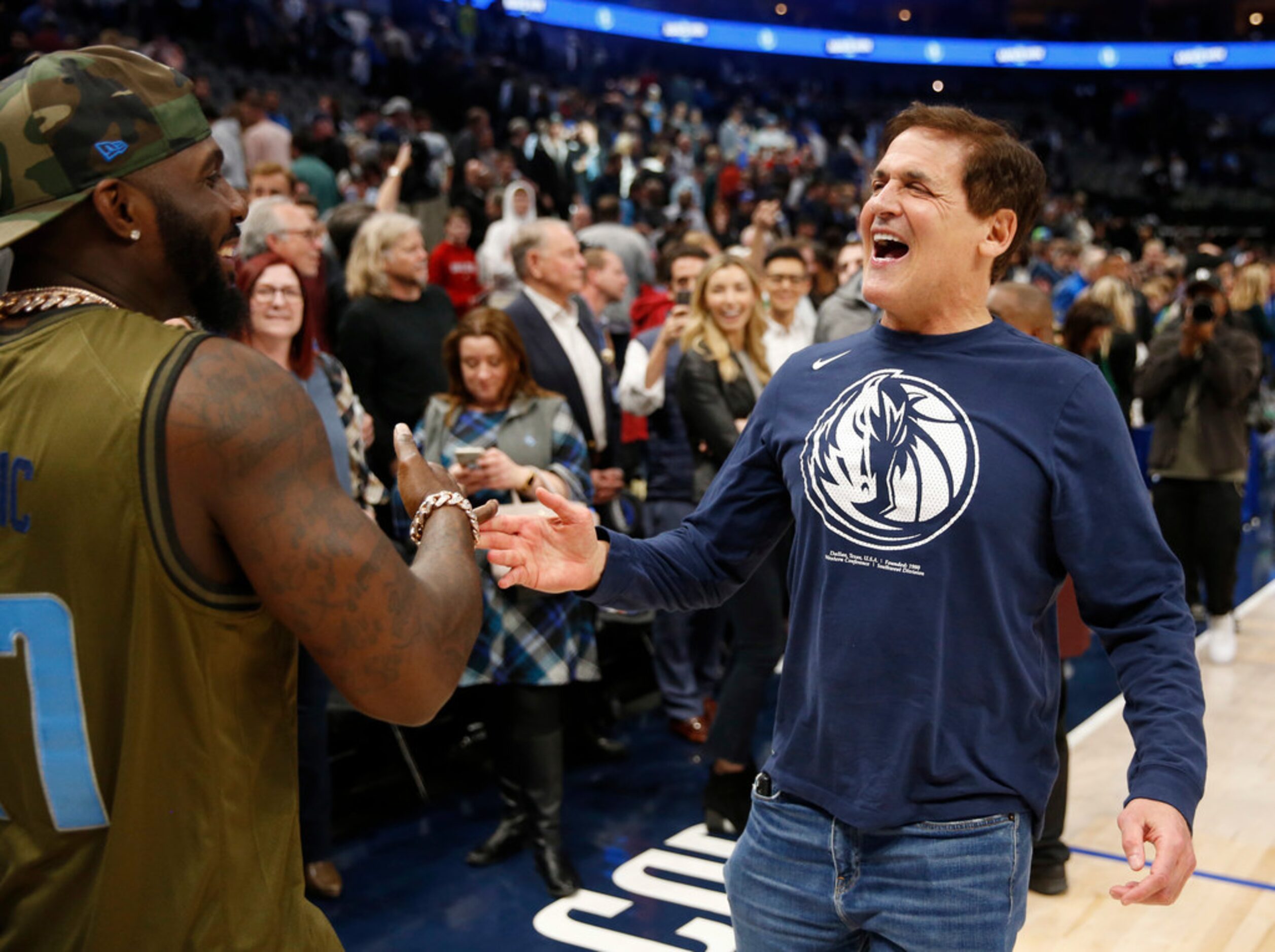 Dallas Mavericks owner Mark Cuban greets former Dallas Cowboys player Dez Bryant after the...