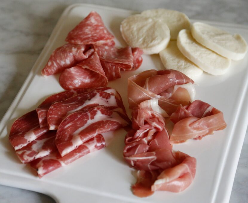 Assortment of cold Italian meats including prosciutto, bologna, capacola, salami and sliced...