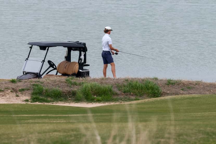 A person fishes in the lake near the 12th green at Maridoe Golf Club in Carrollton. The...
