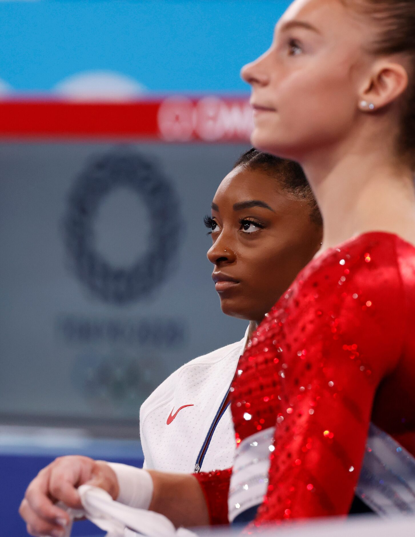 USA’s Jordan Biles watches competition on the uneven bars next to Grace McCallum during the...