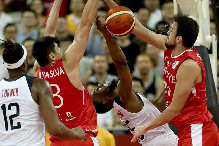 United States' Kemba Walker is blocked by Turkey's Ersan Ilyasova, second from left and...