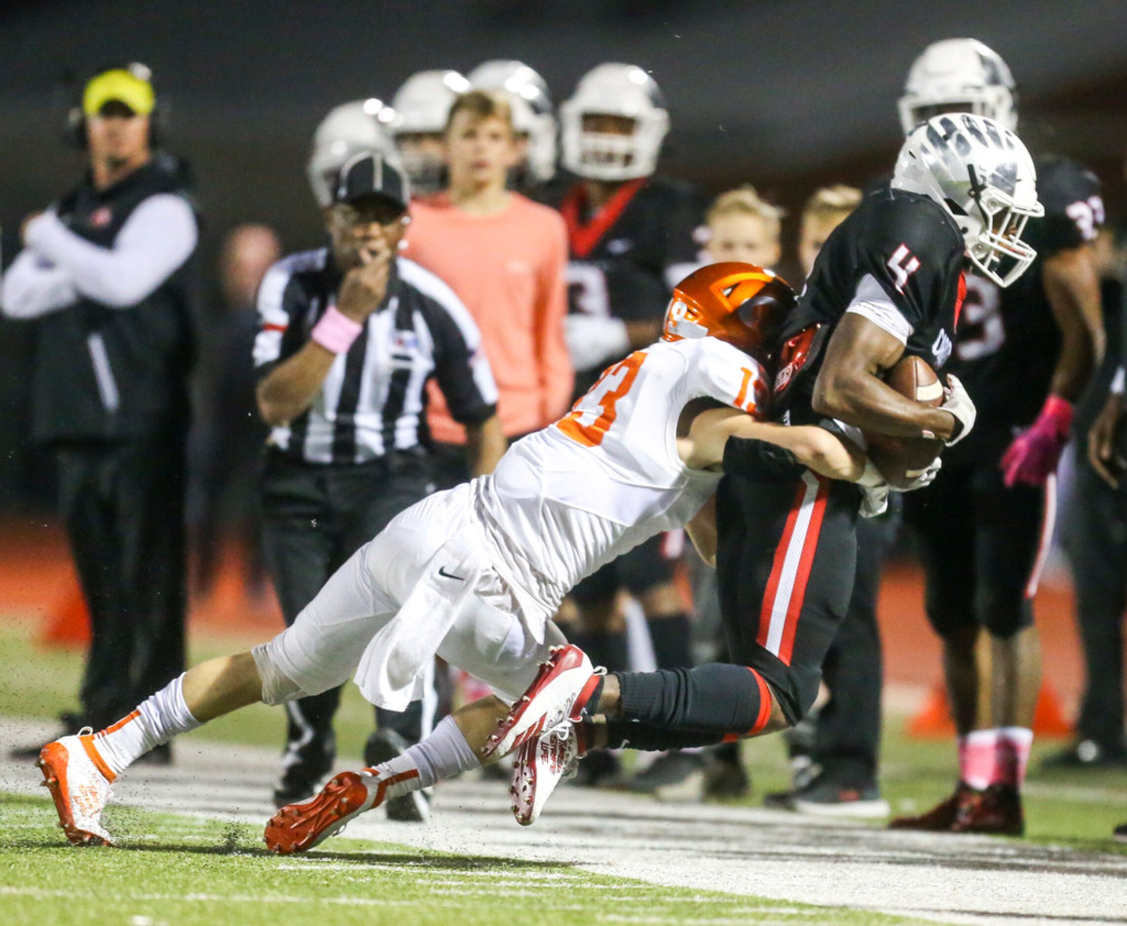 Melissa wide receiver Chase Mapps (4) hauls in a pass as he is defended by Celina Reece...