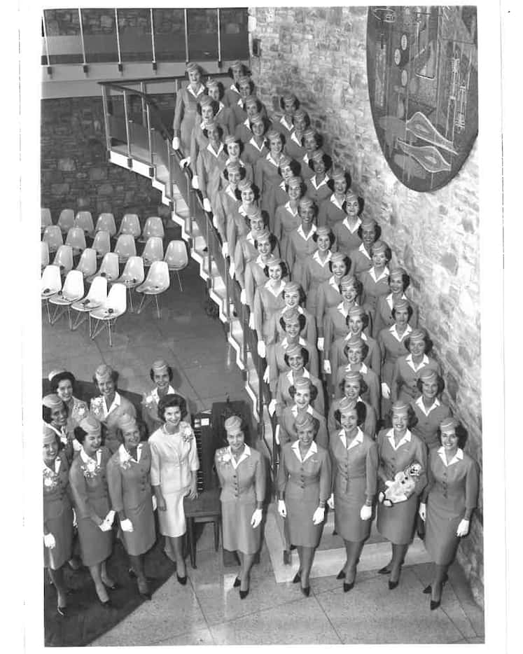 American Airlines flight attendants graduating in 1963 posed for a photo on the staircase at...