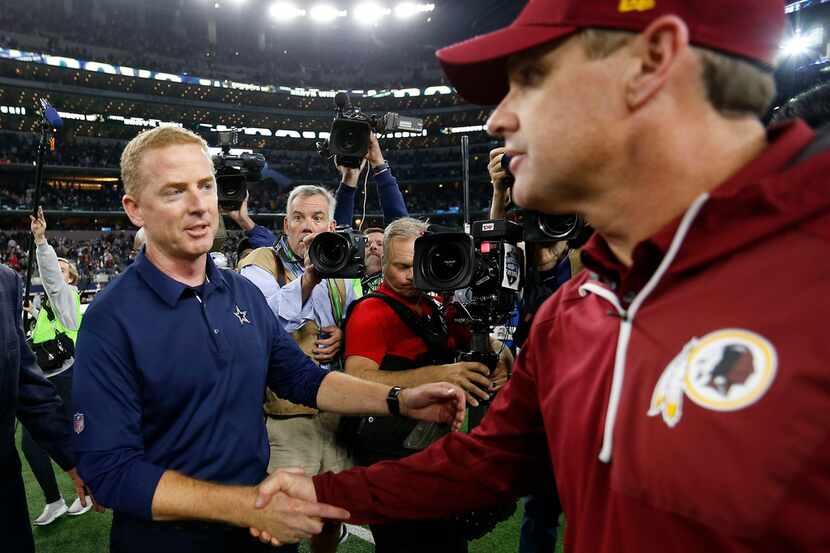 Dallas Cowboys head coach Jason Garrett (left) shakes hands with Washington Redskins head...