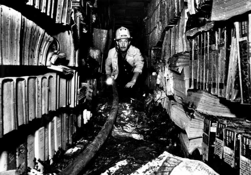 Fire Capt. Don Sturkey inspects the damage caused by the Los Angeles Public Library fire of...