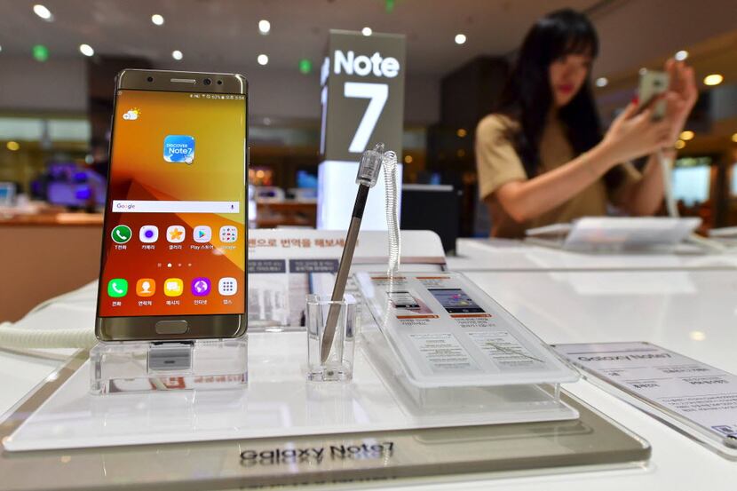 A woman tests a Samsung Galaxy Note7 smartphone at a Samsung showroom in Seoul on September...