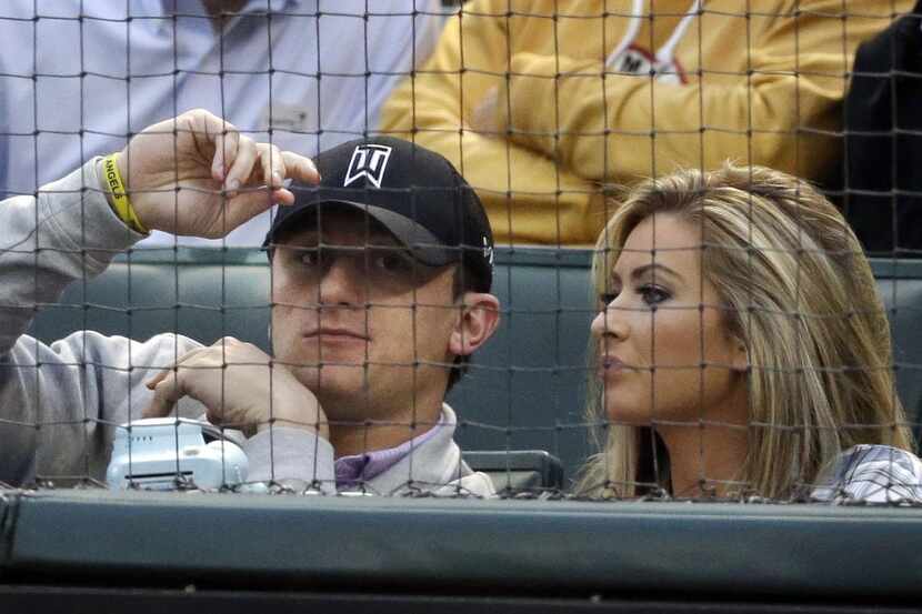 
In this April 2015 file photo, Cleveland Browns quarterback Johnny Manziel, left, sits with...