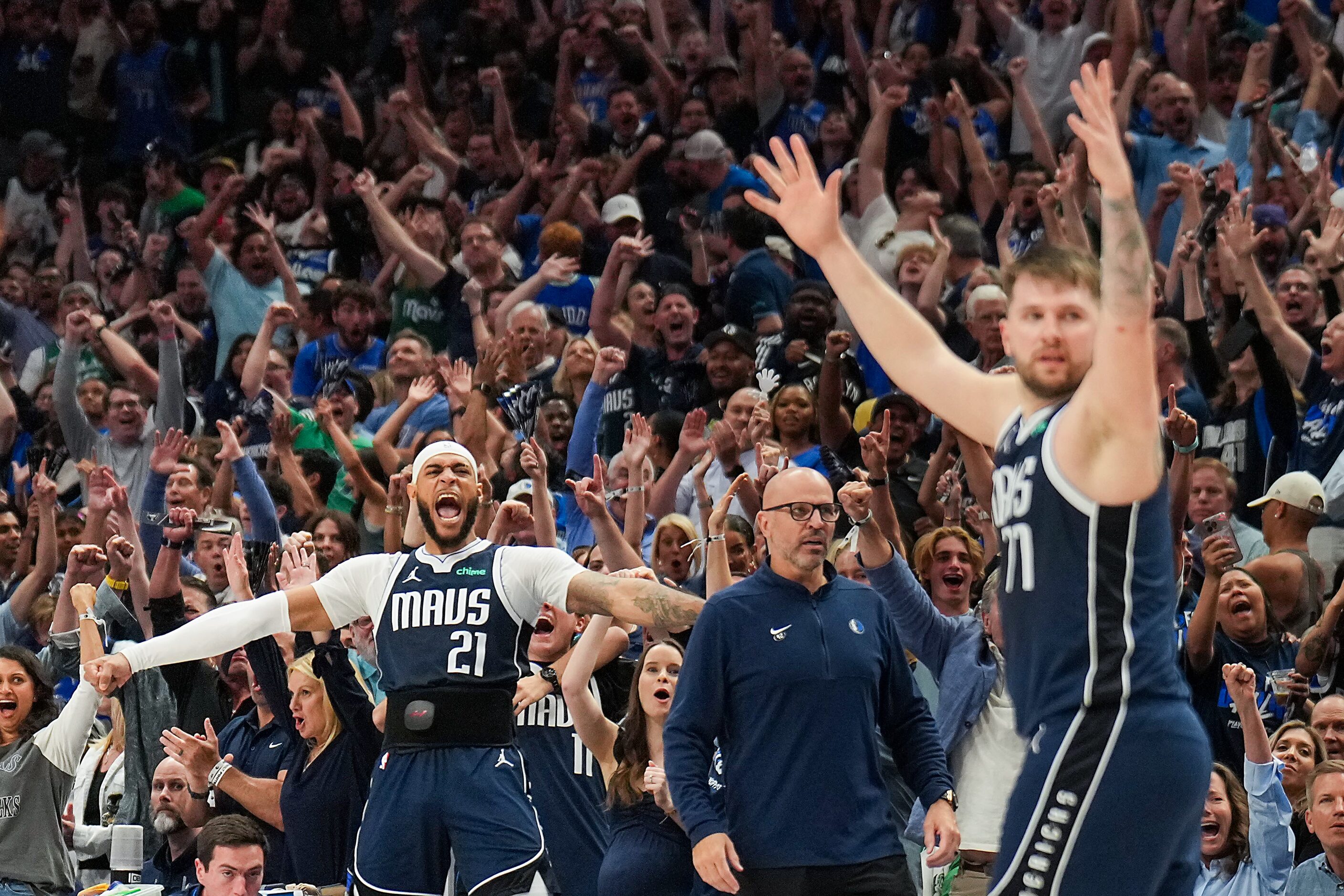 Dallas Mavericks center Daniel Gafford (21) and guard Luka Doncic (77) celebrate a dunk by...