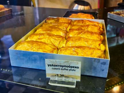 Athens, Greece - June 29, 2018. Galaktoboureko, typical Greek sweet in a storefront of a...