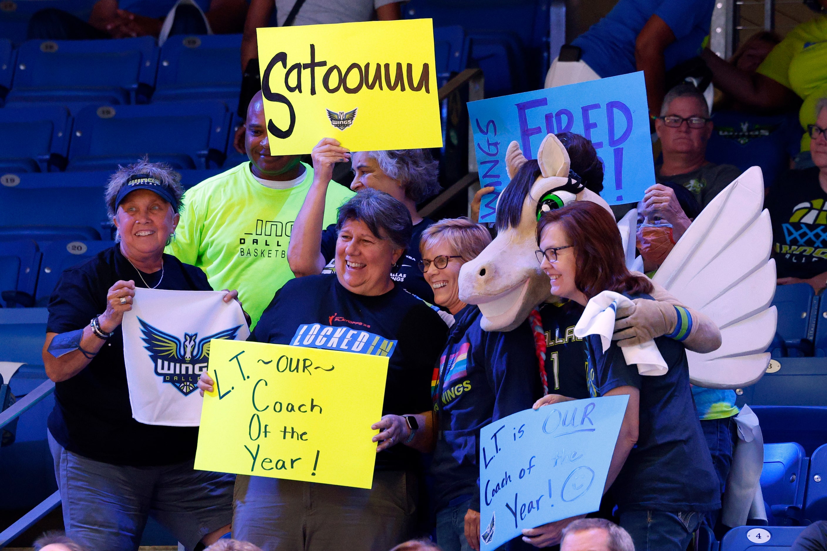 Dallas Wings fans pose for a picture before the first half of a WNBA first-round playoff...