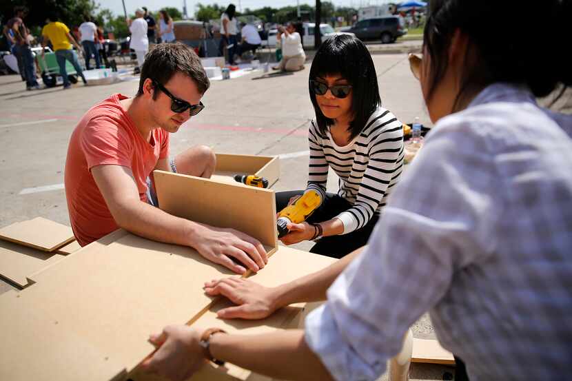 Volunteer architects from left,  Drew Brooks, Sofia Ashraf and Christine Kim help build...